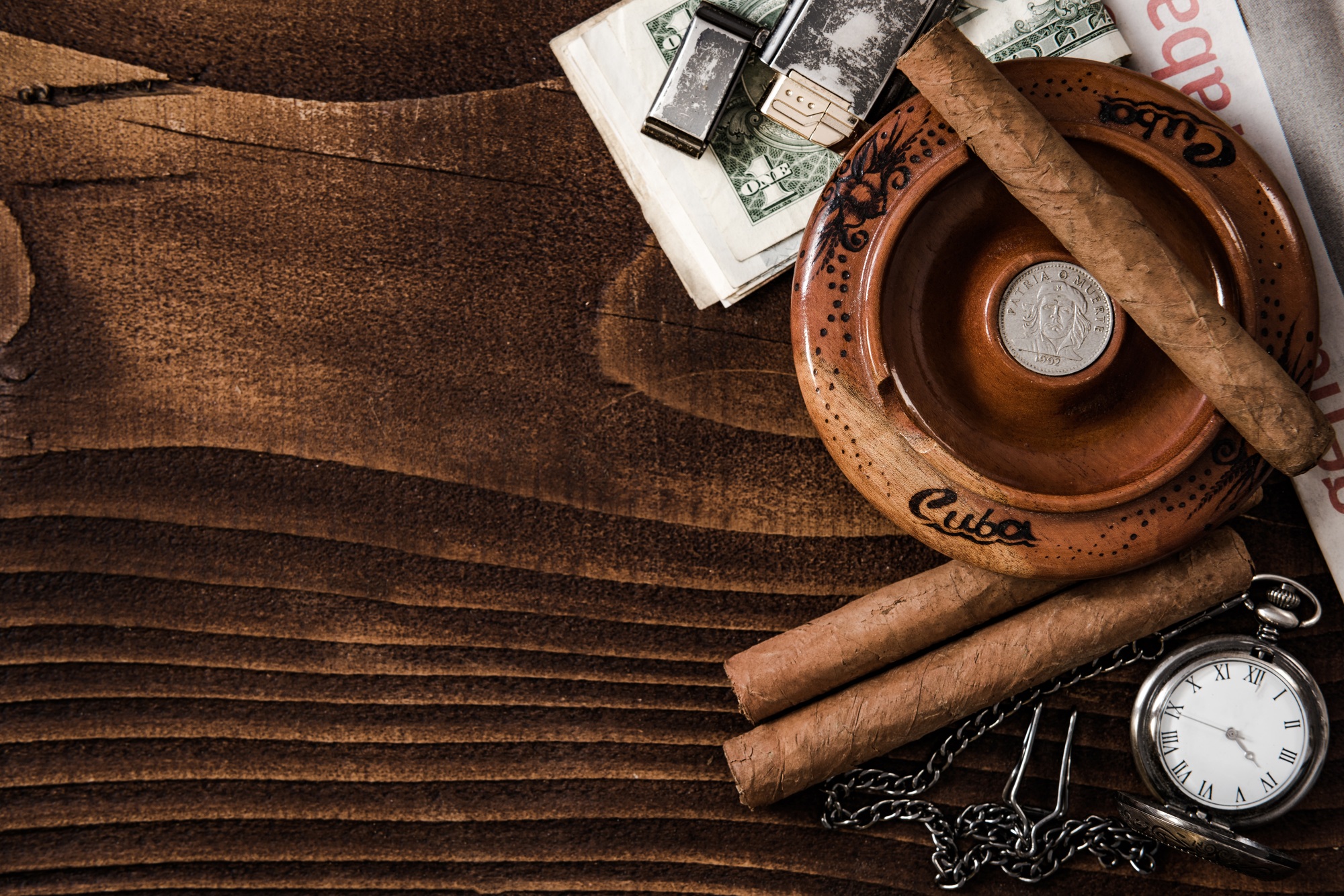 Cuban items,cigars watch on wooden table